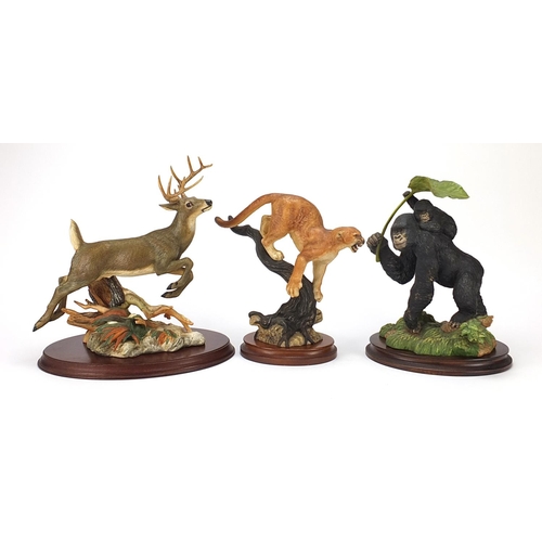 434 - Three Franklin Mint porcelain figure groups to include a leaping stag, gorilla with a baby and a cou... 