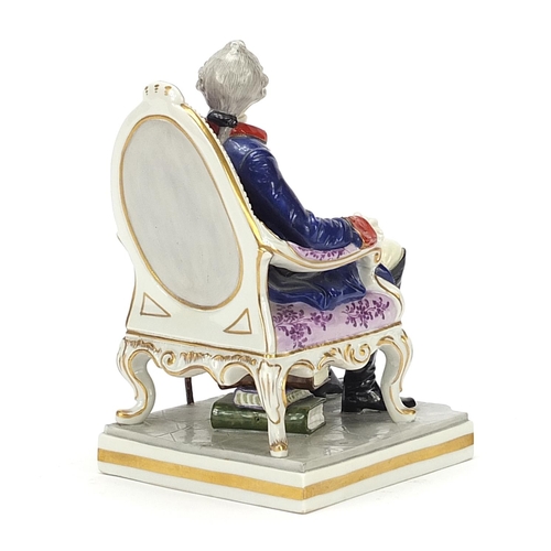 220 - 19th century porcelain Naples figurine depicting a man seated with a walking stick, 17.5cm high