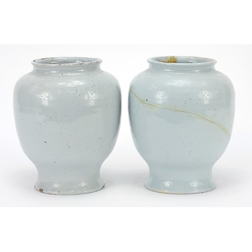 43 - Two 18th century Delft blue and white tin glazed drug jars, 19cm high