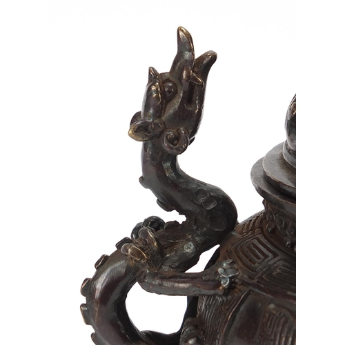 86 - Chinese patinated bronze tripod koro with dragon handles, 22cm high
