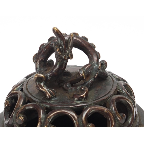 86 - Chinese patinated bronze tripod koro with dragon handles, 22cm high