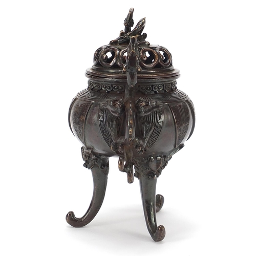 86 - Chinese patinated bronze tripod koro with dragon handles, 22cm high