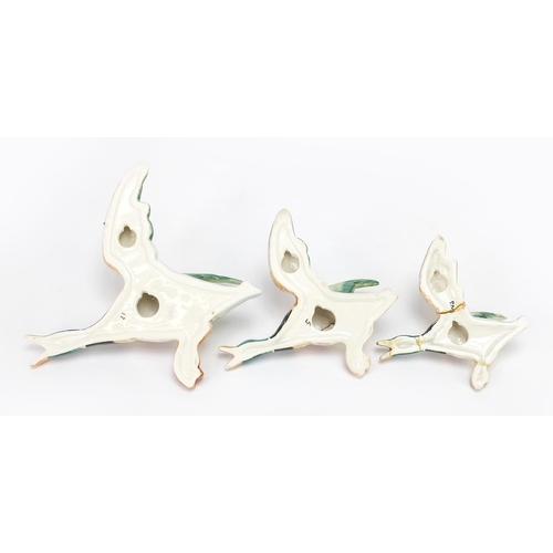 454 - Three porcelain flying ducks wall plaques, the largest 17cm in length