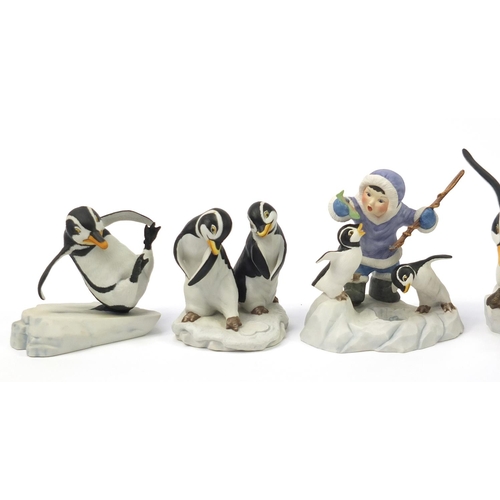 435 - Six Frankin Mint porcelain penguin groups, including two with Eskimo children, the largest 25cm in l... 