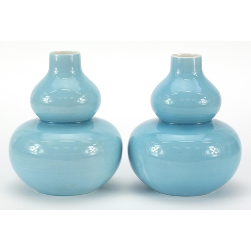 126 - Pair of Chinese porcelain double gourd vases having blue glazes and character marks to the bases, ea... 