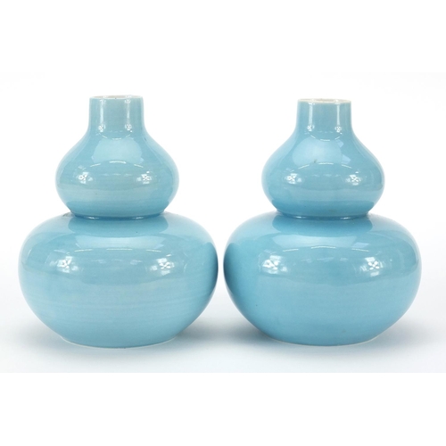 126 - Pair of Chinese porcelain double gourd vases having blue glazes and character marks to the bases, ea... 