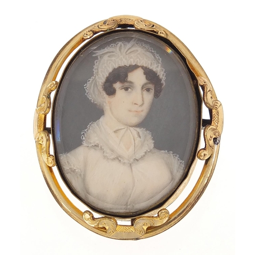 60 - Oval hand painted portrait miniature of a female in Georgian dress housed in a gilt metal brooch mou... 