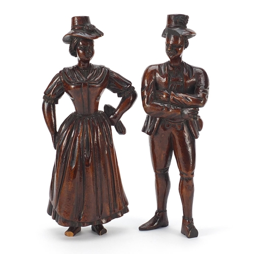13 - Pair of antique continental wood carvings of peasants in 18th century dress, the largest 22cm high