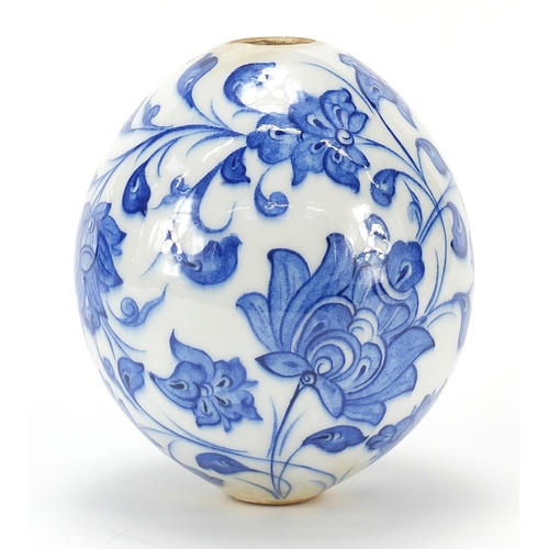 150 - Turkish Iznik pottery hanging mosque ball hand painted with flowers, 13.5cm high