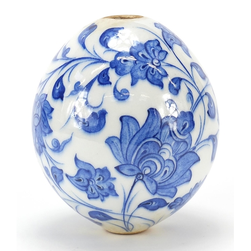 150 - Turkish Iznik pottery hanging mosque ball hand painted with flowers, 13.5cm high