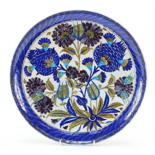 129 - Turkish Iznik pottery plate hand painted with flowers, 33cm in diameter