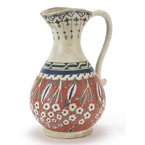 149 - Turkish Kutahya pottery jug hand painted with flowers, 25cm high