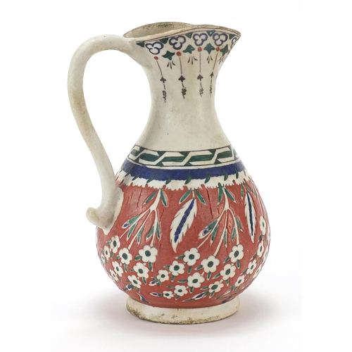 149 - Turkish Kutahya pottery jug hand painted with flowers, 25cm high