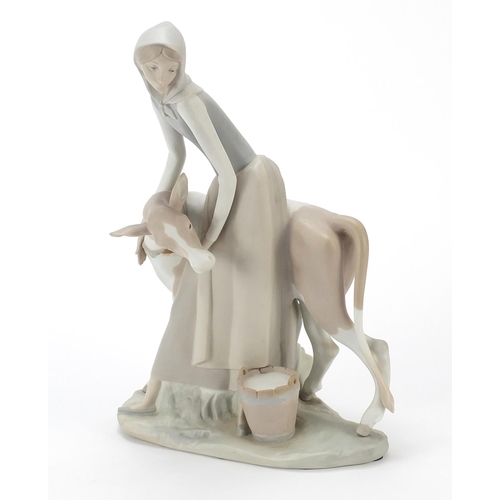 426 - Large Lladro figure group of a female with cow having a matte glaze, 33cm high