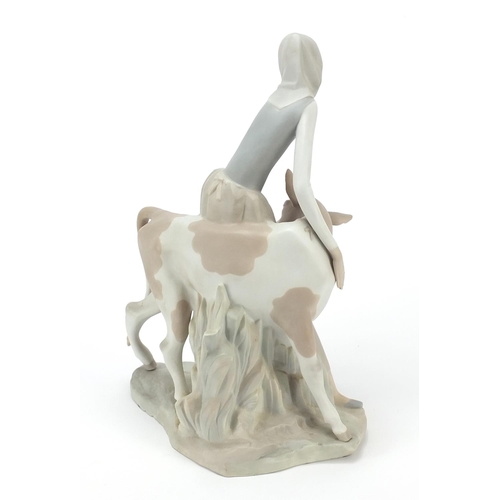 426 - Large Lladro figure group of a female with cow having a matte glaze, 33cm high
