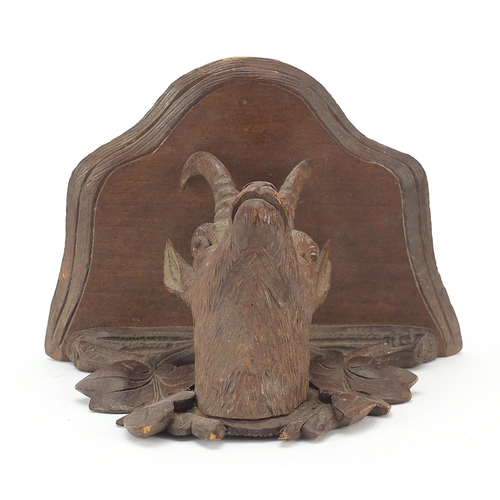 16 - Black Forest carved wall bracket in the form of a goat's head, 11cm high