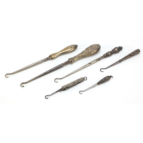 2211 - Edwardian and later silver handled buttonhooks including a folding example, various hallmarks, the l... 