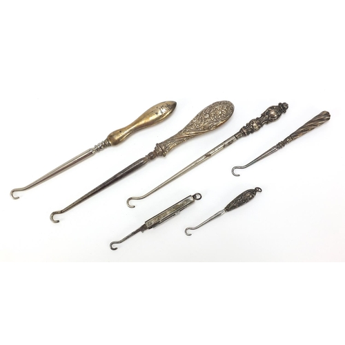 2211 - Edwardian and later silver handled buttonhooks including a folding example, various hallmarks, the l... 