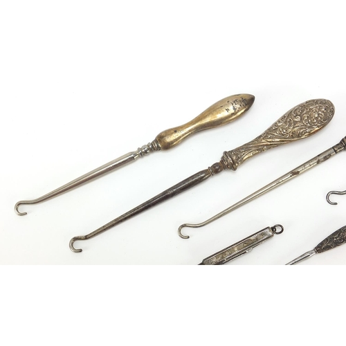 2211 - Edwardian and later silver handled buttonhooks including a folding example, various hallmarks, the l... 