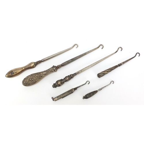 2211 - Edwardian and later silver handled buttonhooks including a folding example, various hallmarks, the l... 