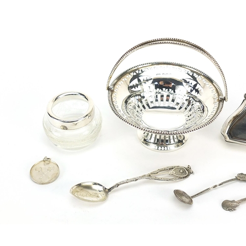 2207 - Silver objects including a concertina purse, pierced bonbon dish with swing handle and tennis medal,... 