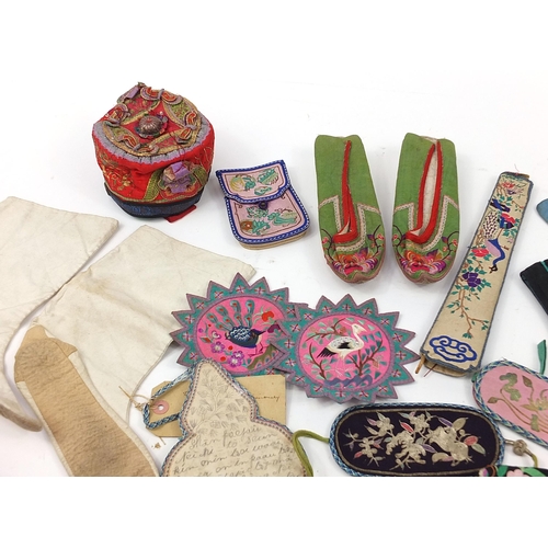 318 - Chinese textiles and a silver coloured gourd ornamental hanging including embroidered shoes, fan cas... 