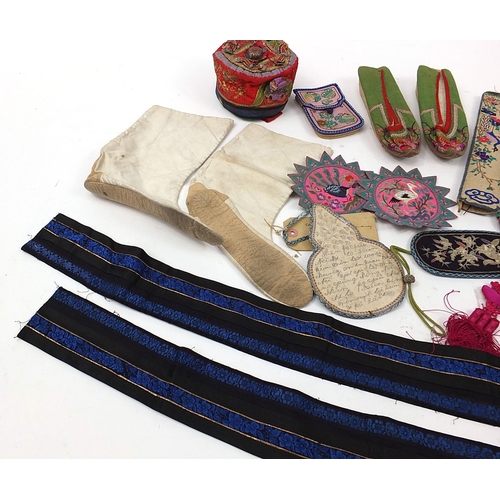 318 - Chinese textiles and a silver coloured gourd ornamental hanging including embroidered shoes, fan cas... 