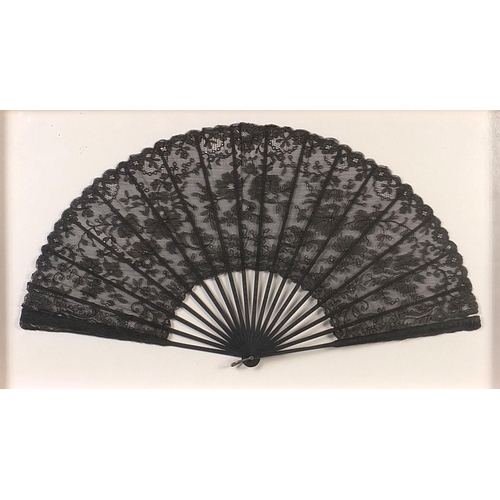 352 - Three Victorian fans comprising two mourning examples and one with bone sticks, each housed in a gla... 