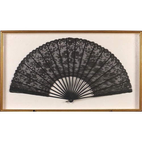 352 - Three Victorian fans comprising two mourning examples and one with bone sticks, each housed in a gla... 