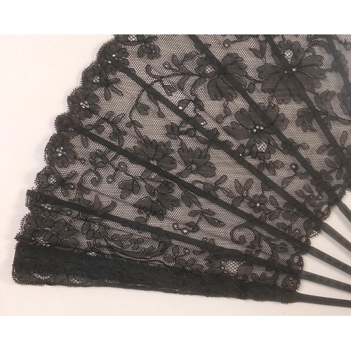 352 - Three Victorian fans comprising two mourning examples and one with bone sticks, each housed in a gla... 