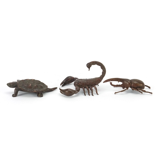 306 - Three Japanese patinated bronze animals comprising scorpion, tortoise and Hercules beetle, each with... 