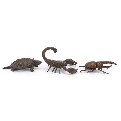 306 - Three Japanese patinated bronze animals comprising scorpion, tortoise and Hercules beetle, each with... 