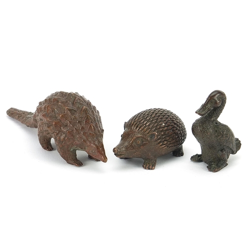 256 - Three Japanese patinated bronze animals comprising armadillo, hedgehog and duck, each with impressed... 