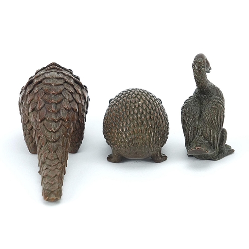 256 - Three Japanese patinated bronze animals comprising armadillo, hedgehog and duck, each with impressed... 