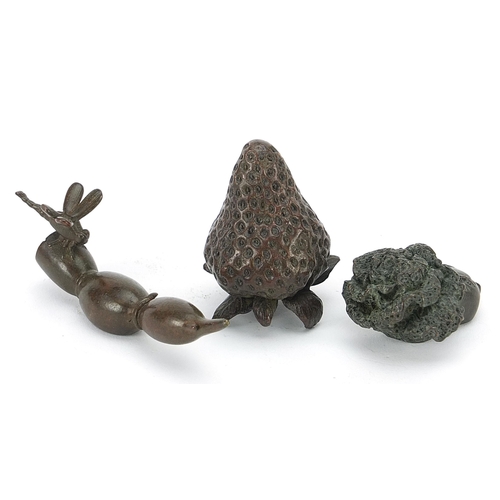 127 - Three Japanese patinated bronze vegetables and fruits, each with impressed marks, the largest 8cm in... 