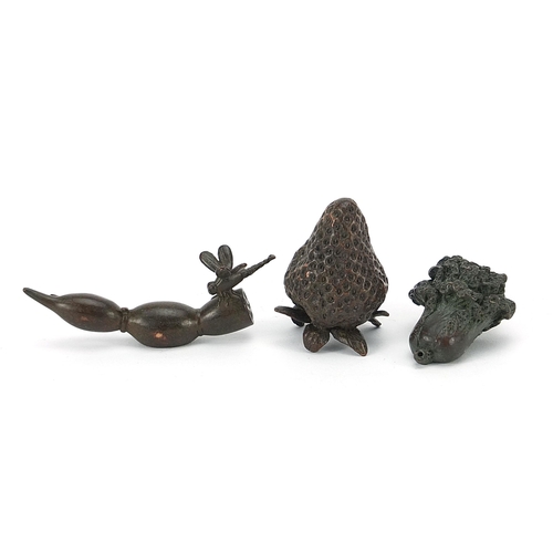 127 - Three Japanese patinated bronze vegetables and fruits, each with impressed marks, the largest 8cm in... 