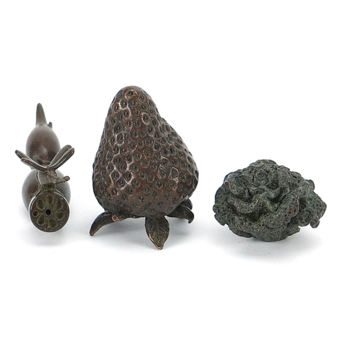 127 - Three Japanese patinated bronze vegetables and fruits, each with impressed marks, the largest 8cm in... 