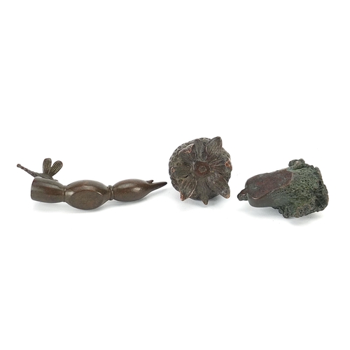 127 - Three Japanese patinated bronze vegetables and fruits, each with impressed marks, the largest 8cm in... 