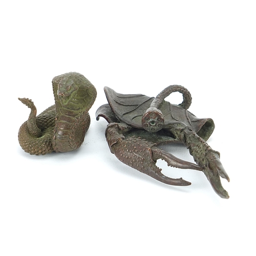 308 - Two Japanese patinated bronze animals comprising cobra and crab, the largest 10.5cm in length