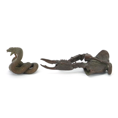 308 - Two Japanese patinated bronze animals comprising cobra and crab, the largest 10.5cm in length