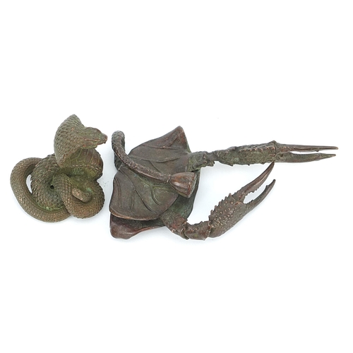 308 - Two Japanese patinated bronze animals comprising cobra and crab, the largest 10.5cm in length