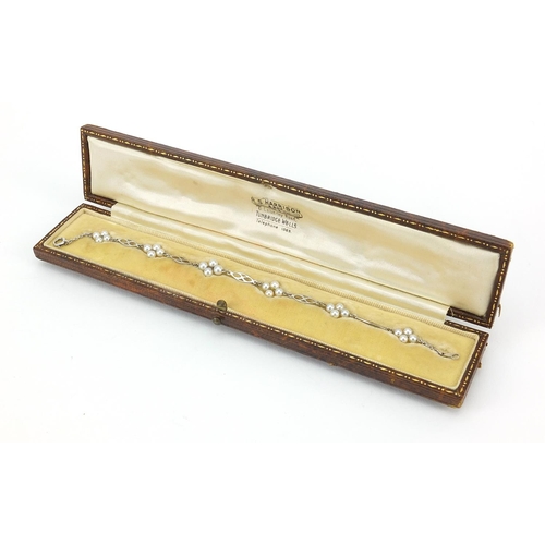 1604 - 9ct white gold pearl bracelet housed in an R S Harrison & Son fitted box, 18cm in length, 3.0g