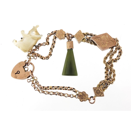 1630 - Victorian 9ct gold watch chain bracelet with 9ct gold love heart padlock, carved mother of pearl pig... 