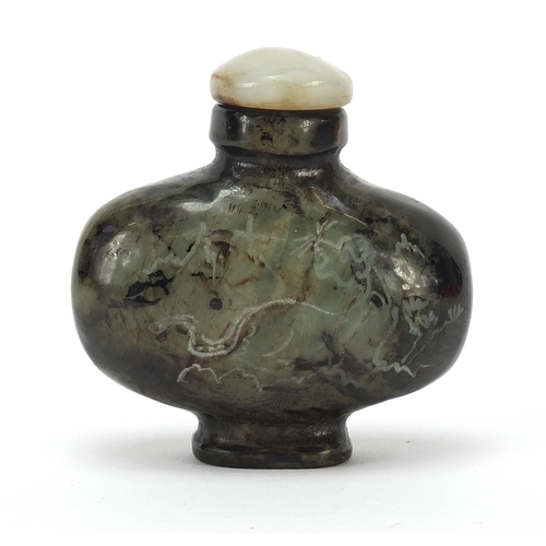 303 - Chinese jade snuff bottle carved with a dragon in a mountainous landscape and calligraphy, 6cm high