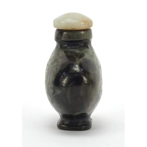 303 - Chinese jade snuff bottle carved with a dragon in a mountainous landscape and calligraphy, 6cm high