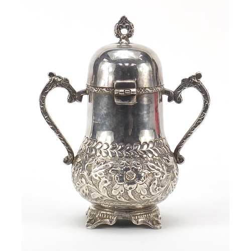 2226 - Silver coloured metal vessel with hinged lid and twin handles, 19cm high