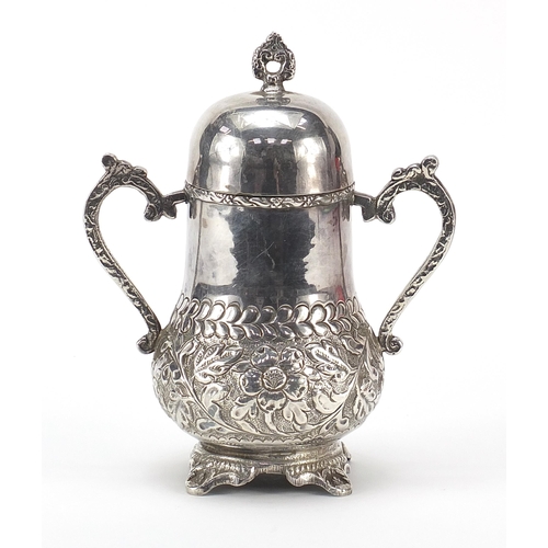 2226 - Silver coloured metal vessel with hinged lid and twin handles, 19cm high