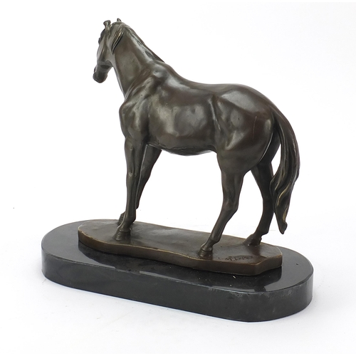 112 - Patinated bronze horse raised on a black slate base, 33cm in length