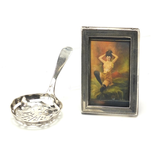 2194 - Antique continental silver sifting spoon and a miniature rectangular silver easel photo frame, the s... 