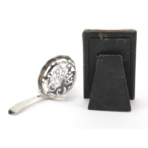 2194 - Antique continental silver sifting spoon and a miniature rectangular silver easel photo frame, the s... 